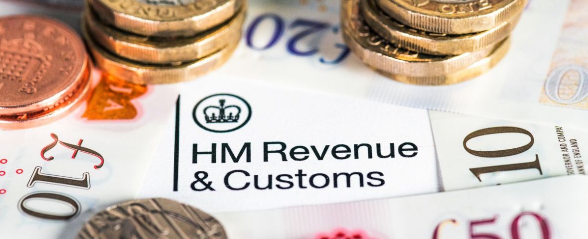 A collection of modern British banknotes surrounding the HM Revenue & Customs heading on a UK Government tax form.